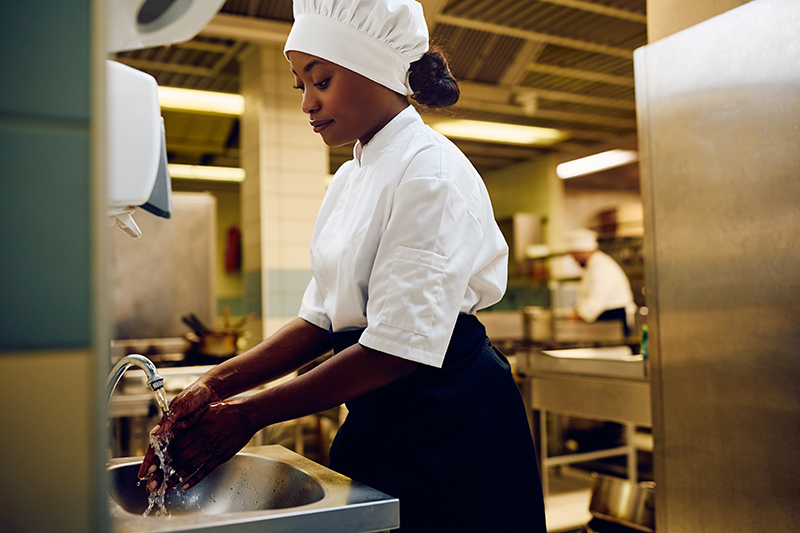 Restaurant employee washing hands